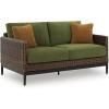 imageSignature Design by Ashley Horizon Hall Vintage Outdoor Nuvella Weather Resistant Fabric Resin Wicker Loveseat with Cushion and 2 Accent Pillows Green ampamp Dark BrownOutdoor Loveseat with Cushion