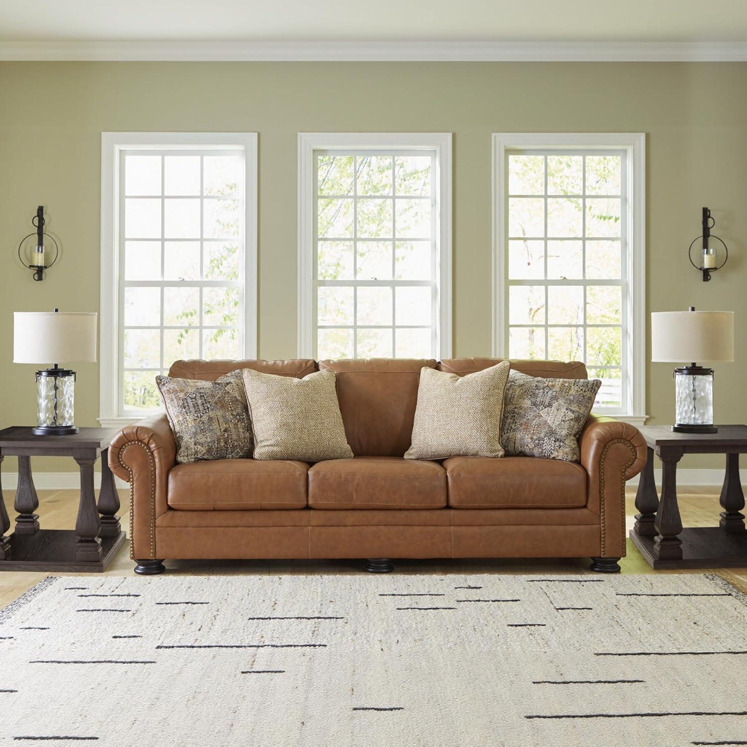 imageSignature Design by Ashley Shadsburne Rustic Faux Leather Sofa Sleeper with BiFold Memory Foam Mattress Nailhead Trim and 2 Throw Pillows Queen BrownDark Brown